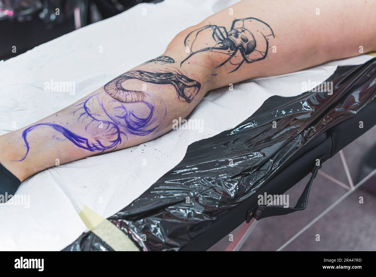 process of creating a new tattoo on a customers leg snake tattoo high quality photo 2RA47RD