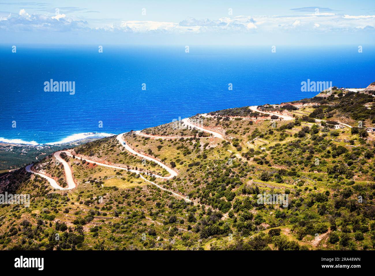 A long twisting road leads out of the mountains to the western coast of Crete, Greece. Stock Photo
