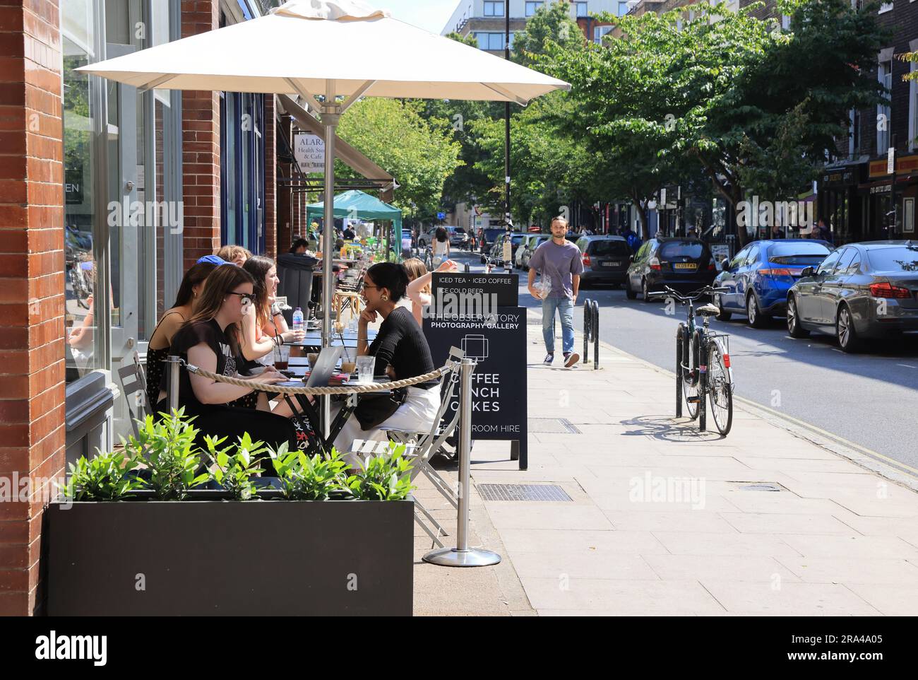 Cafes in spring sunshine on Marchmont Street in Bloomsbury, central London, UK Stock Photo