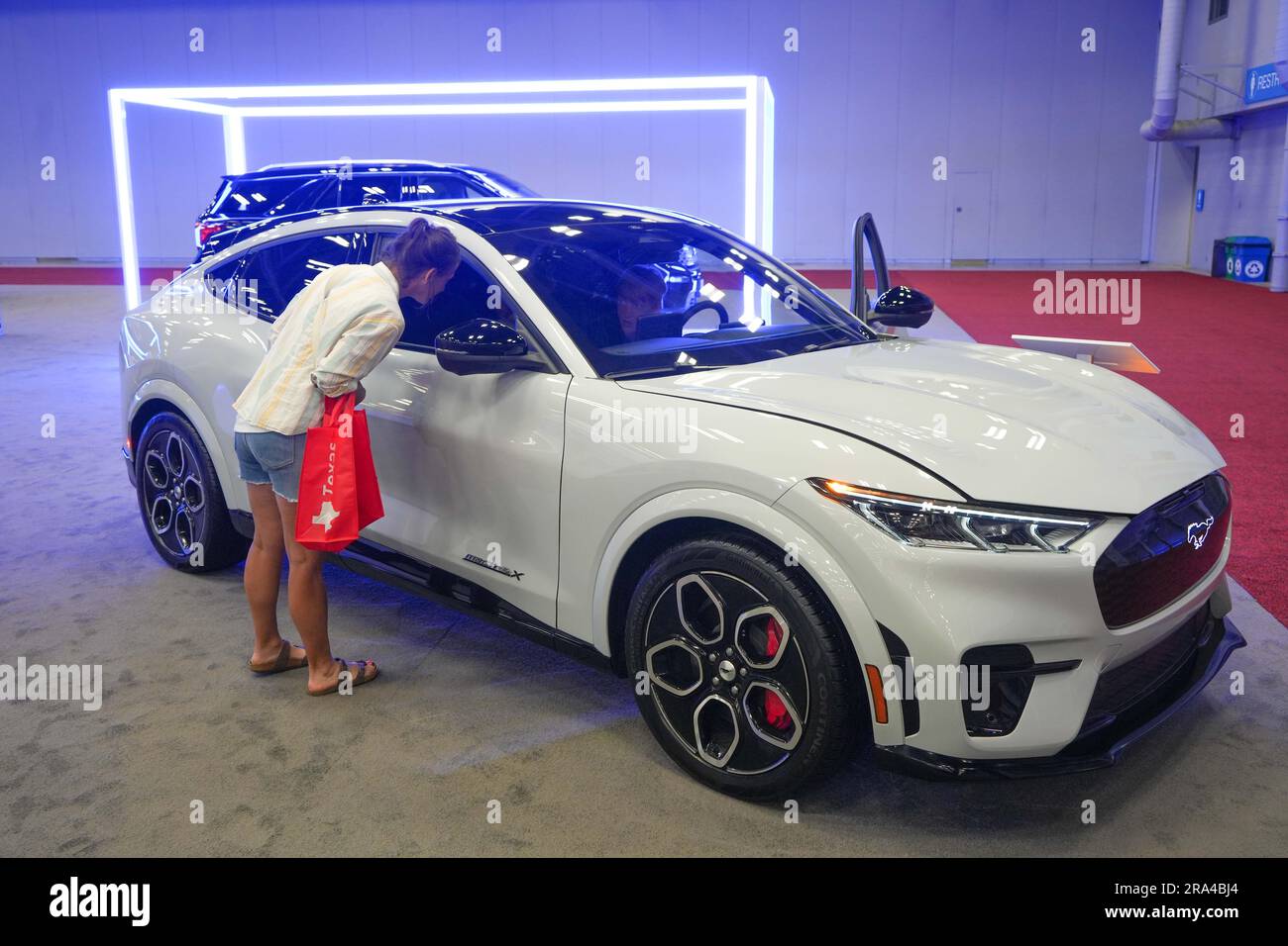 Austin, USA. 30th June, 2023. People look at an allelectric vehicle at