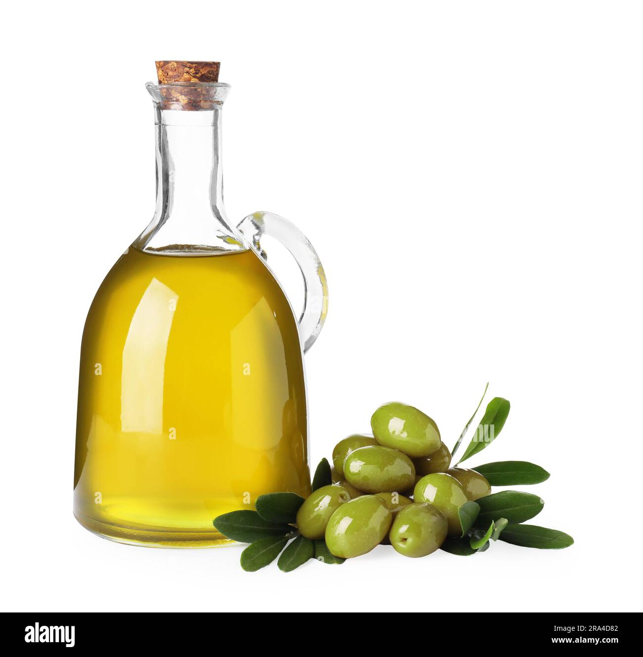 Glass jug of cooking oil, ripe olives and green leaves isolated on