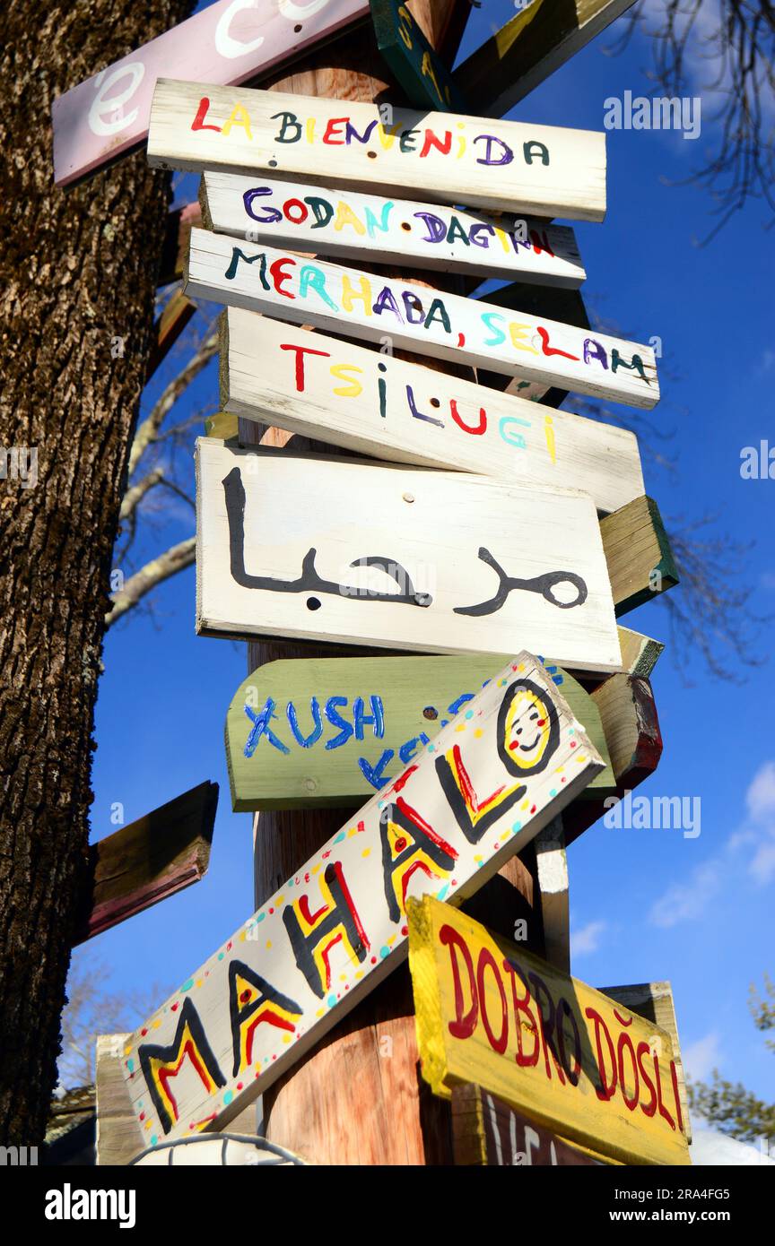 A group of signs at an exit of a business thanks their customers in many languages Stock Photo
