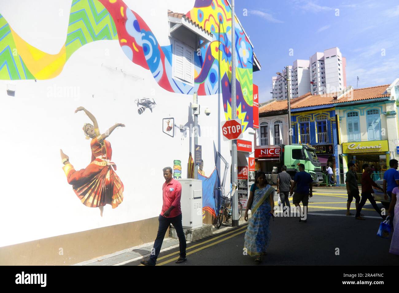Art mural of woman in sari dancing whilst being surveilled by a drone, Little India, Singapore. No MR or PR Stock Photo