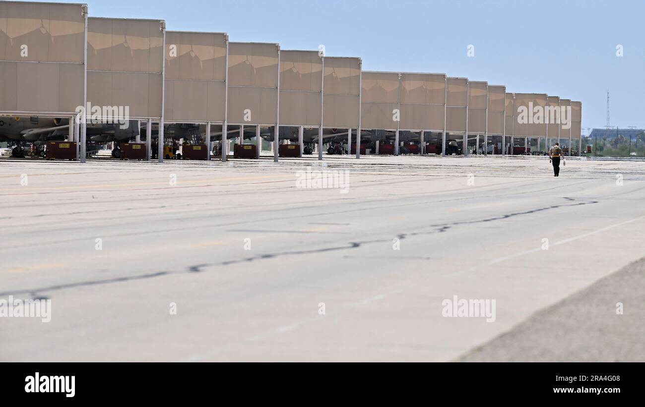 A maintenance Airman, assigned to the 355th Maintenance Group, walks across the flightline at Davis-Monthan Air Force Base, Ariz., June 29, 2023. The first production model, the A-10A Thunderbolt II aircraft, was delivered to DMAFB in October 1975, and the upgraded A-10C aircraft reached initial operational capability in September 2007.  (U.S. Air Force photo by Senior Airman William Turnbull) Stock Photo