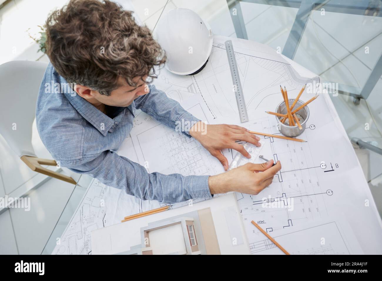 Young handsome architect engineer working on design plan Stock Photo