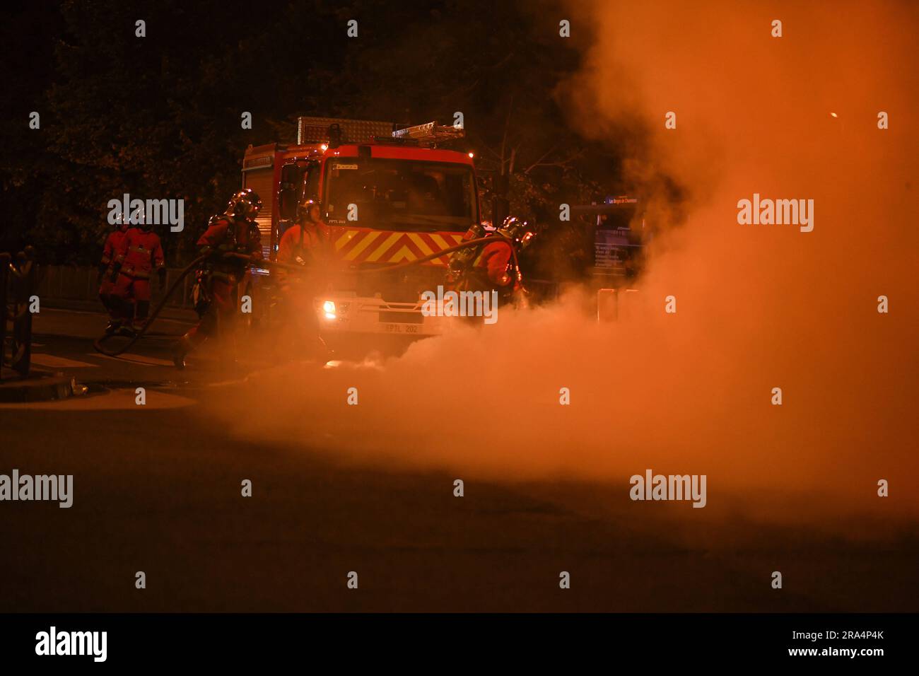 Charenton, France. 01st July, 2023. Firefighters extinguish fires set on trash cans under riot