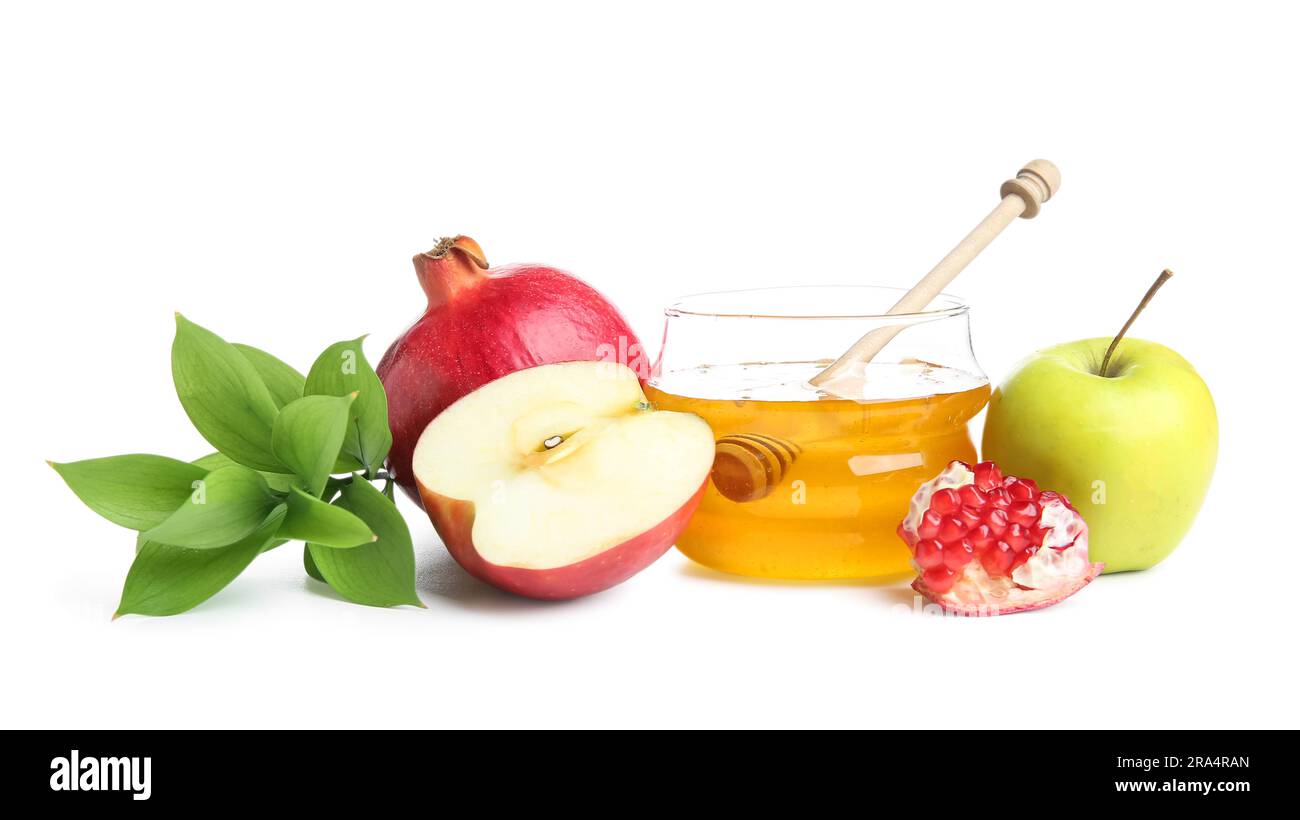 Jar with sweet honey, fruits and plant branch on white background. Rosh