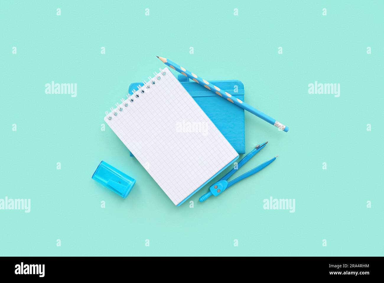 Blank notebook with different stationery on turquoise background Stock ...