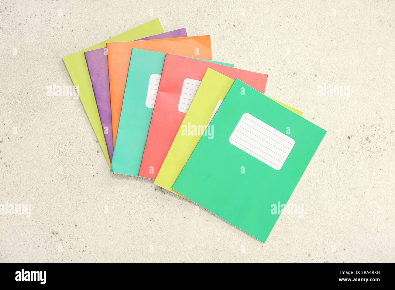 Different colorful notebooks on grunge light background Stock Photo