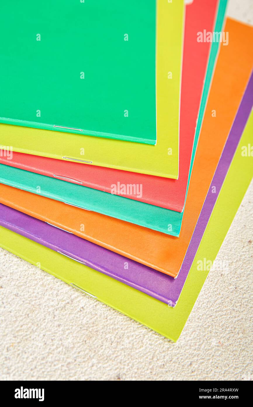 Different colorful notebooks on grunge light background Stock Photo