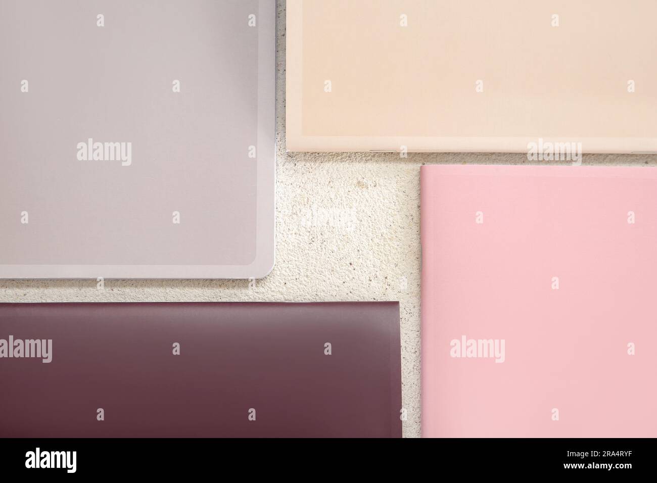 Different colorful notebooks on grunge light background Stock Photo