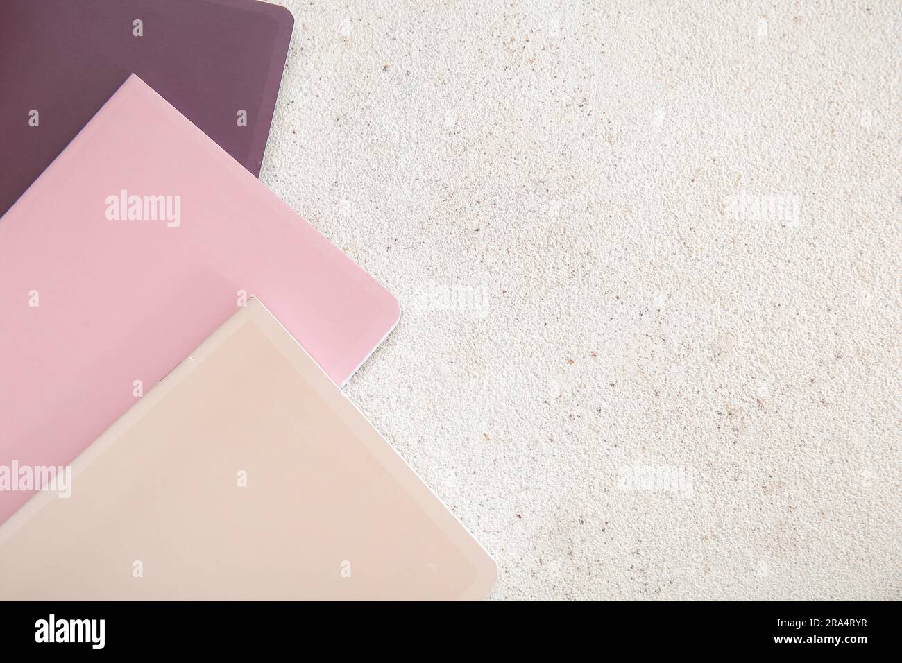 Different colorful notebooks on grunge light background Stock Photo