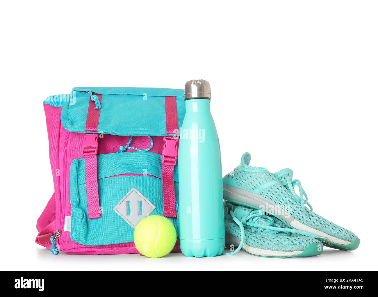 Backpack with sneakers, tennis ball and bottle of water isolated on