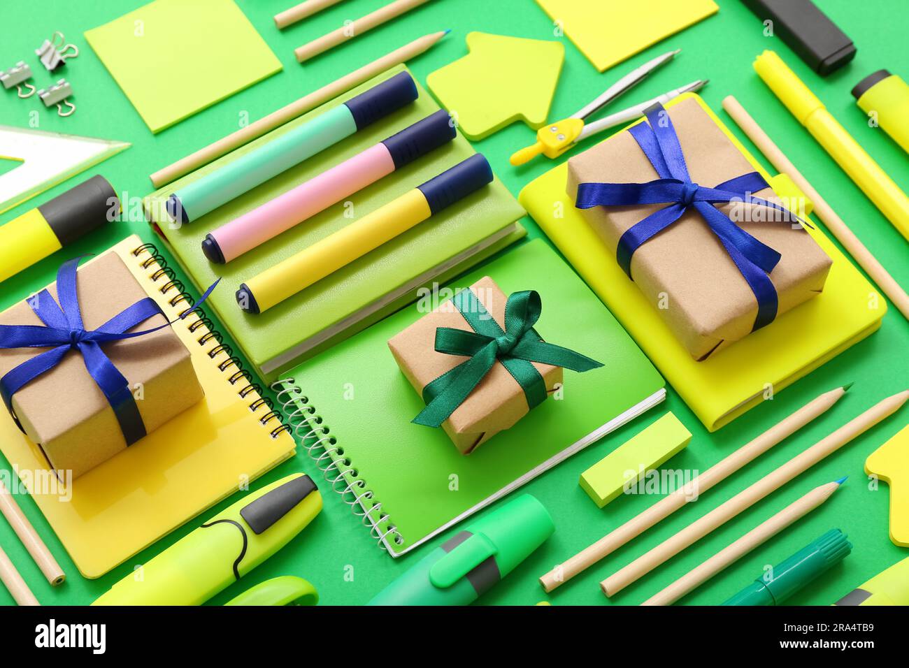 Gift boxes with different stationery on green background Stock Photo