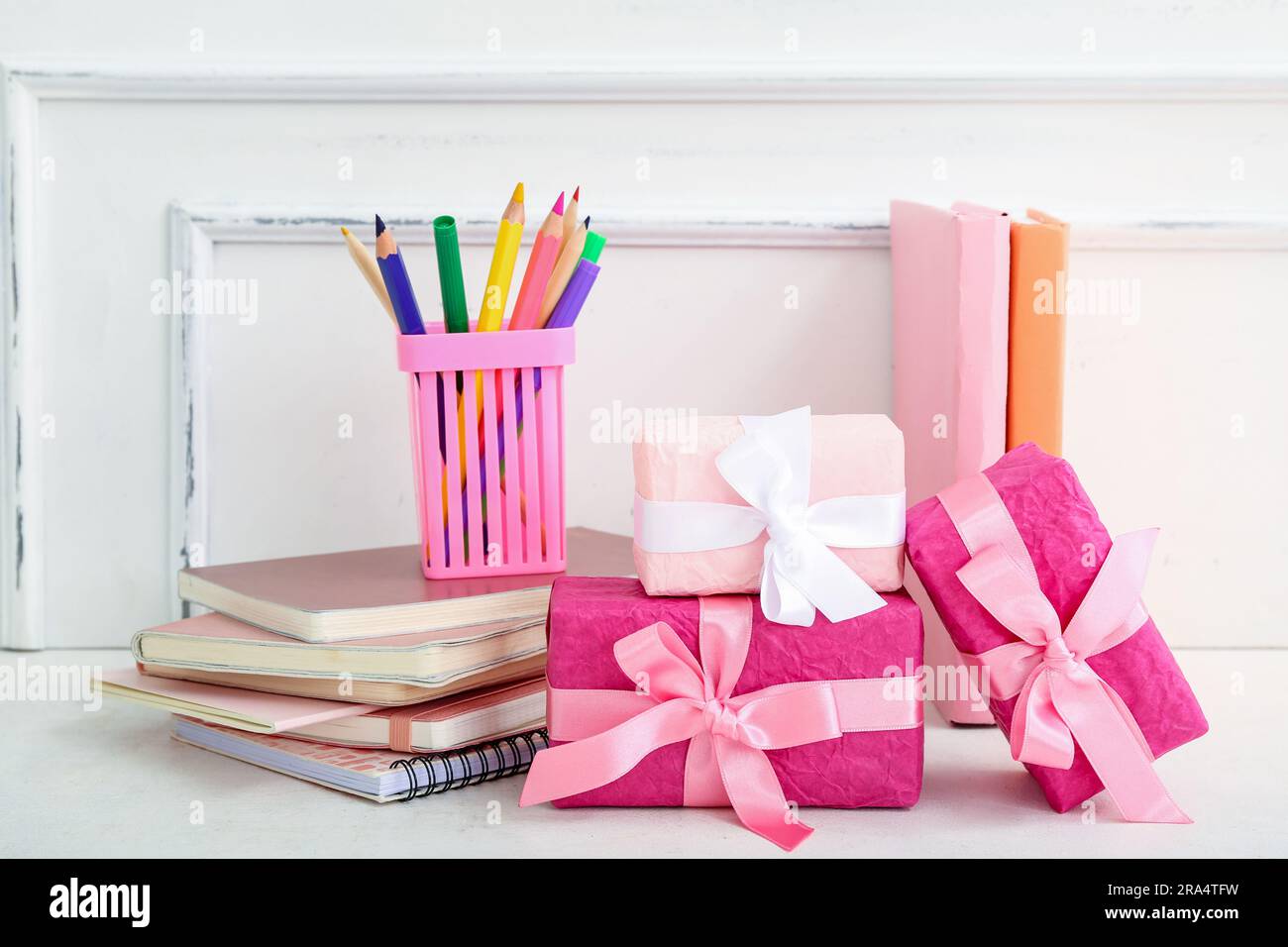 Gift boxes with books and different stationery on white table Stock Photo