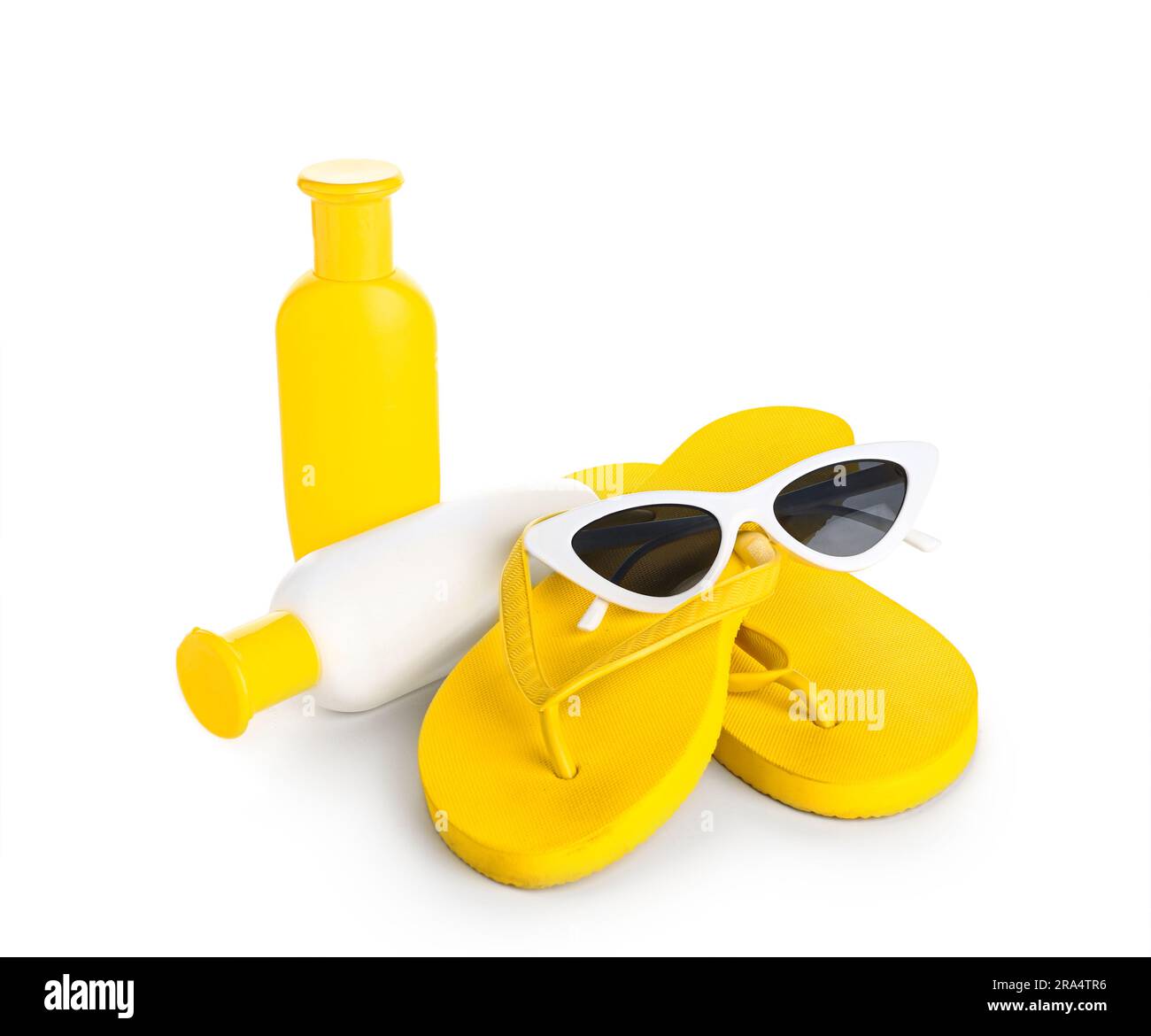 Sunglasses with flip flops and bottles of sunscreen cream isolated on ...