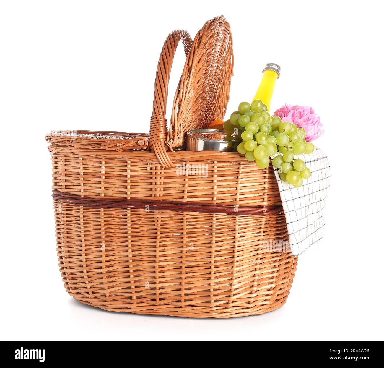 Wicker basket with tasty food for picnic, juice and peony flower on ...