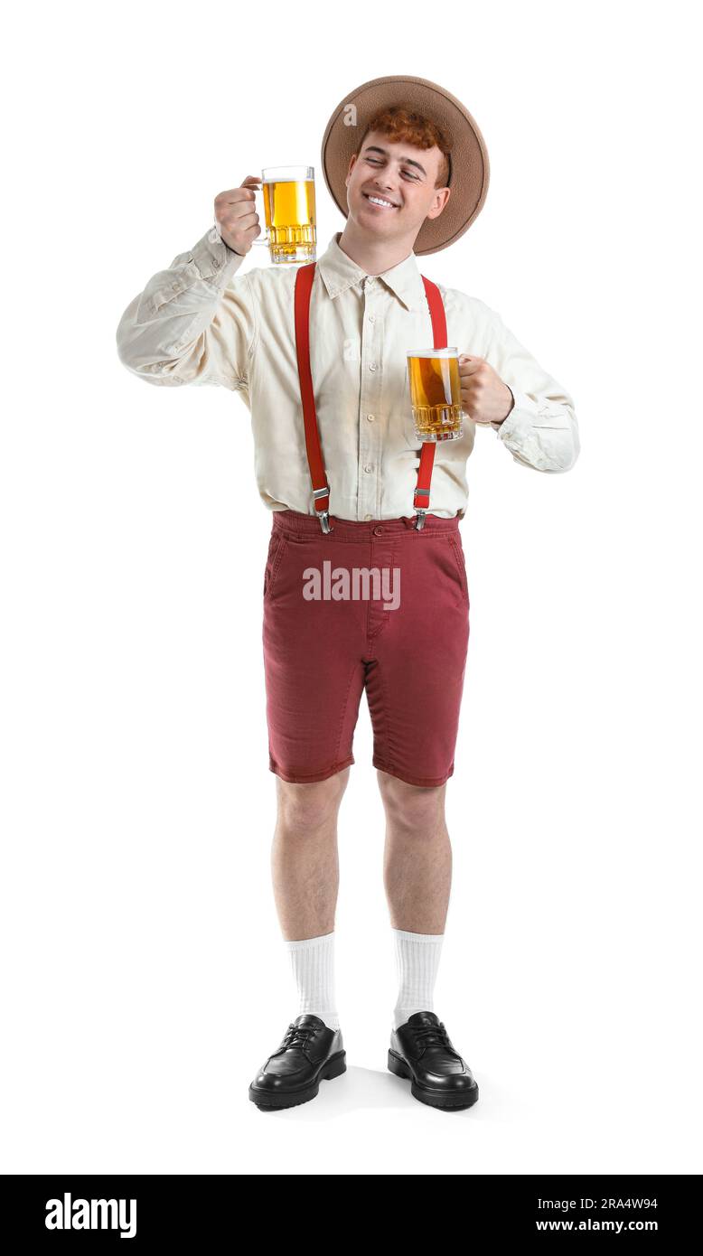 Young man in traditional German clothes with beer on white background