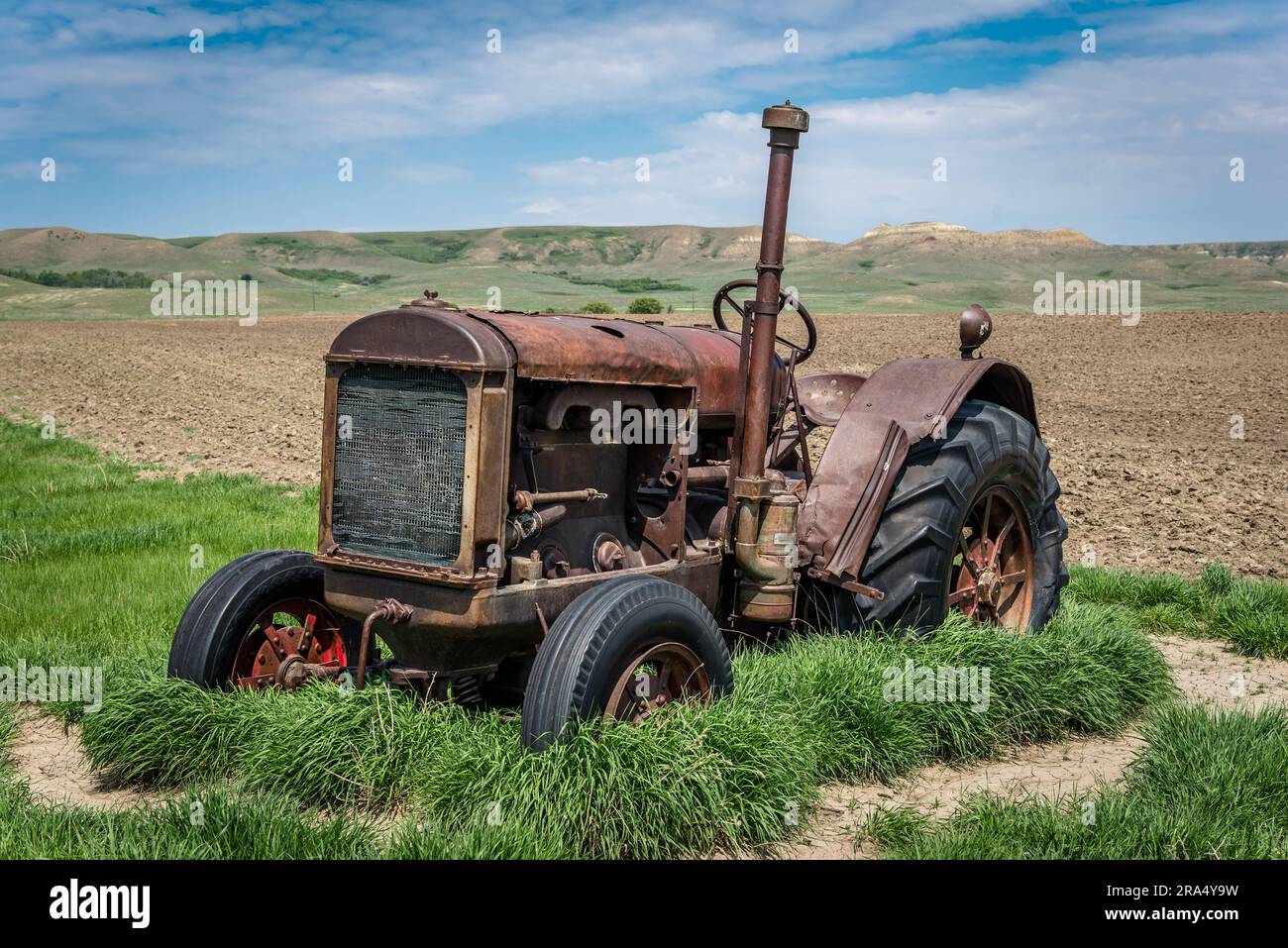 A vintage tractor abandoned in the Frenchman River Valley near Eastend, SK Stock Photo
