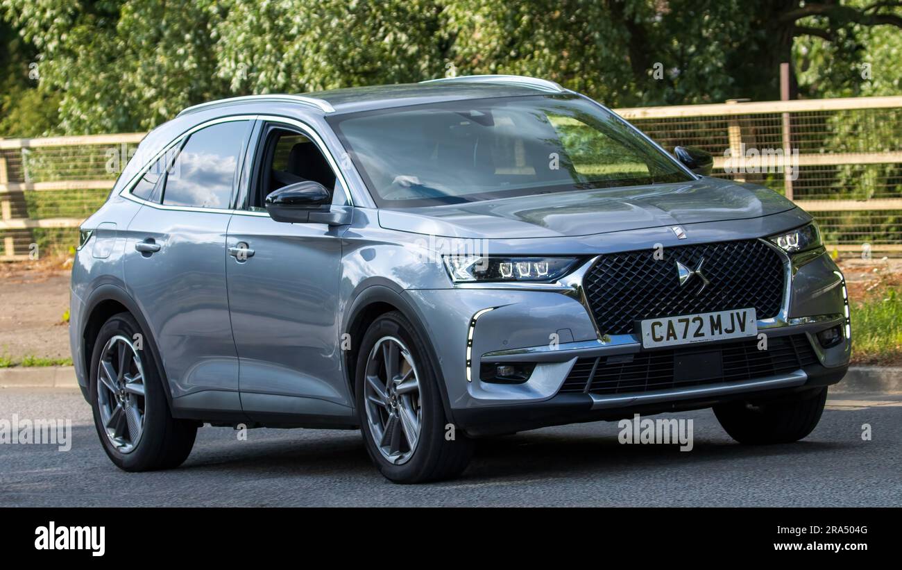 Milton Keynes,UK - June 24th 2023. 2022 grey DS DS7 CROSSBACK RIVOLI PHEV AUTO hybrid electric car travelling on an English country road Stock Photo
