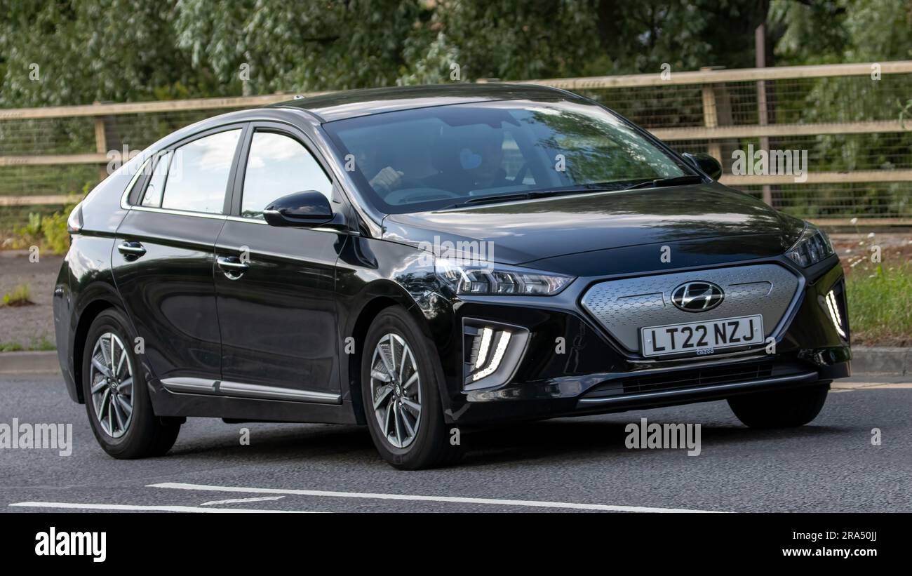 Milton Keynes,UK - June 24th 2023. 2022 black HYUNDAI IONIQ PREMIUM EV electric car travelling on an English country road Stock Photo