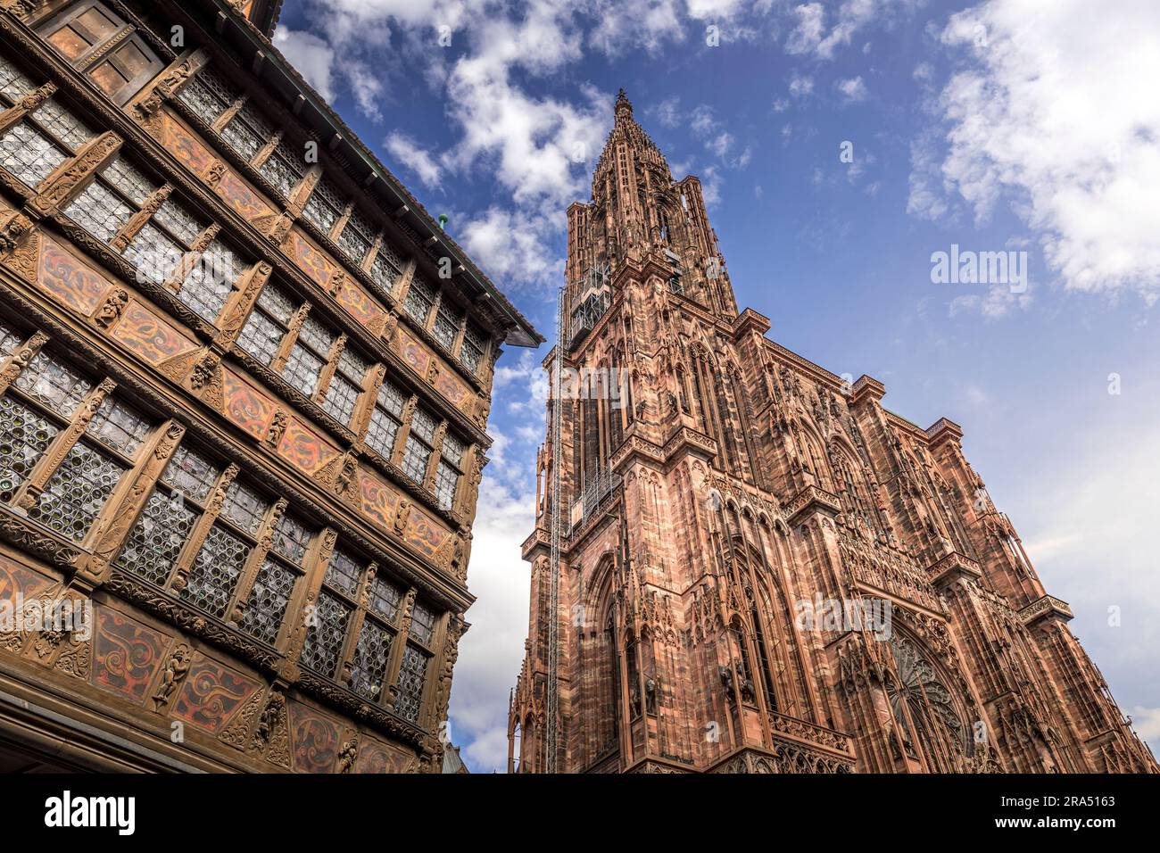 Strasbourg, France - June 19, 2023: Strasbourg Cathedral seen from the cathedral square with old half timbered houses Stock Photo