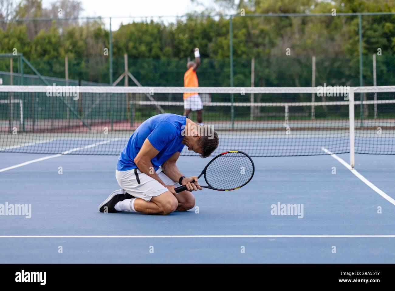 Diverse male tennis players playing tennis and losing game on outdoor