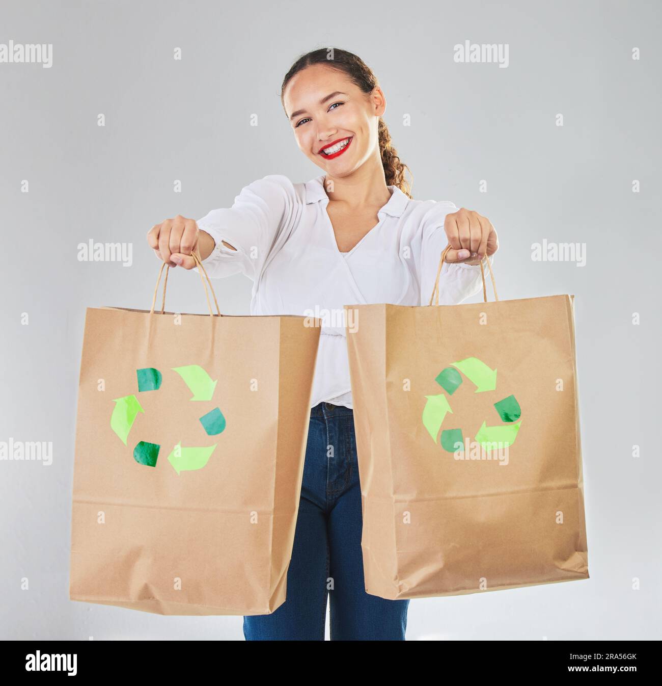 Recycle, environment and woman with bag, sustainability with shopping in portrait and logo on white background. Environmental, retail and eco friendly Stock Photo