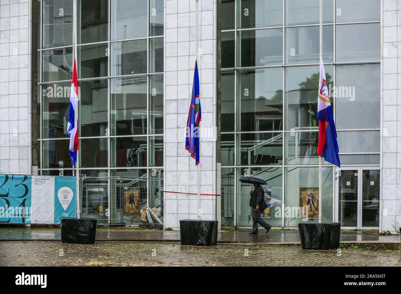 AMSTERDAM - During Keti Koti, the flags of the Netherlands, Suriname, Curaçao, Aruba, Bonaire, Sint Maarten, Sint Eustatius and Saba hang at half mast on the forecourt of the Amsterdam city hall. This year marks the 150th anniversary of the end of slavery under Dutch rule. ANP EVA PLEVIER netherlands out - belgium out Credit: ANP/Alamy Live News Stock Photo