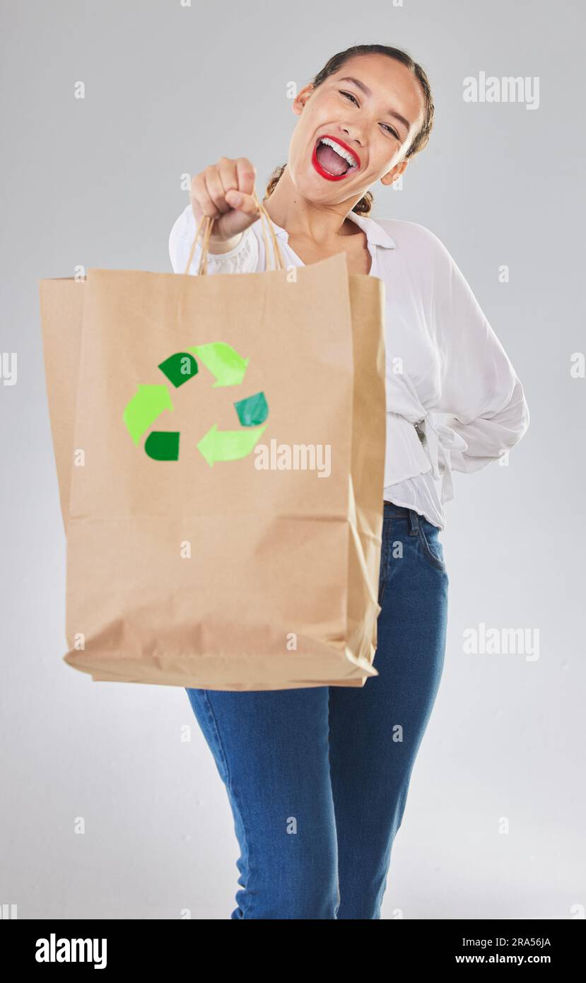 Recycling, environment and happy woman with bag, carbon footprint and sustainability with shopping on white background. Environmental, retail and eco Stock Photo