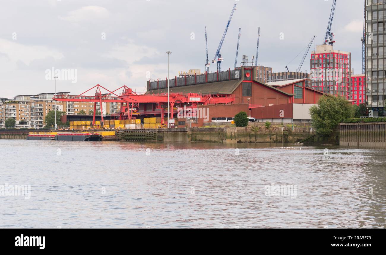 Western Riverside Waste Authority Recycling Facility next to the River Wandle, a tributary of the River Thames, Wandsworth, London, SW18, England, U.K. Stock Photo