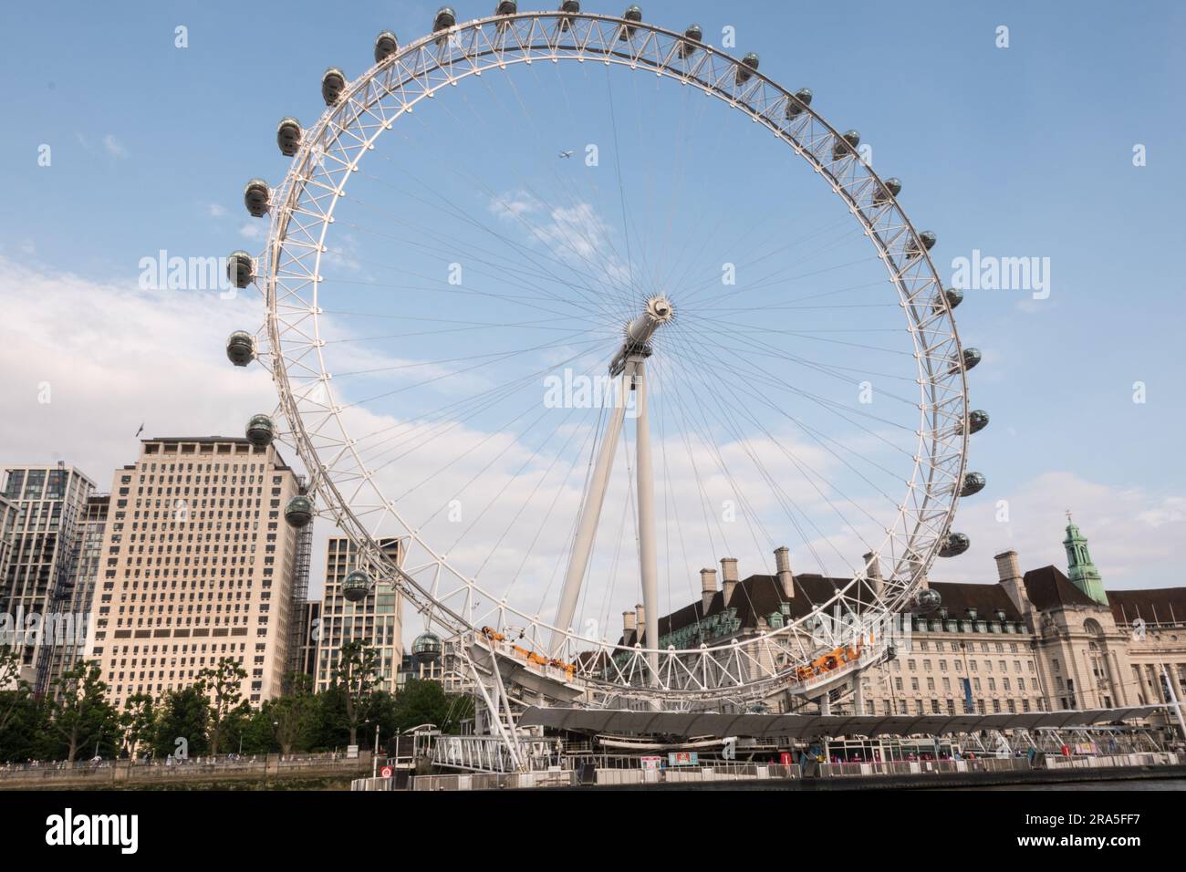 The Millenium Wheel sandwiched between the Shell Building and the old London County Hall on the South Bank of the River Thames, London, England, U.K. Stock Photo