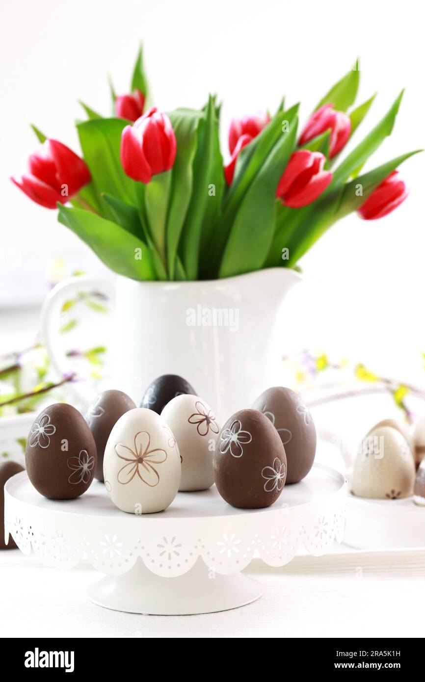 Easter eggs with tulips on the table Stock Photo - Alamy