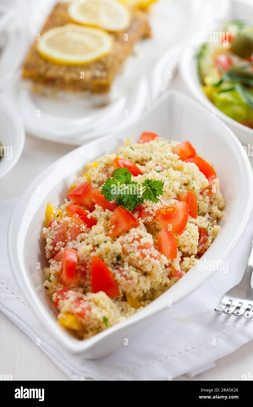 Couscous salad with tomato, pepper with olives Stock Photo