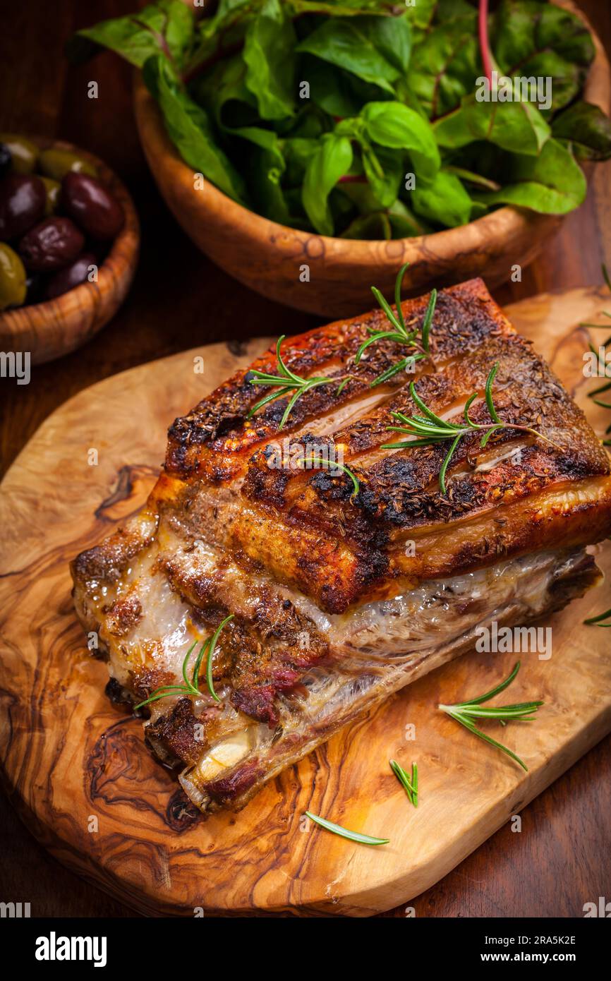 Roasted pork with olives and salad Stock Photo