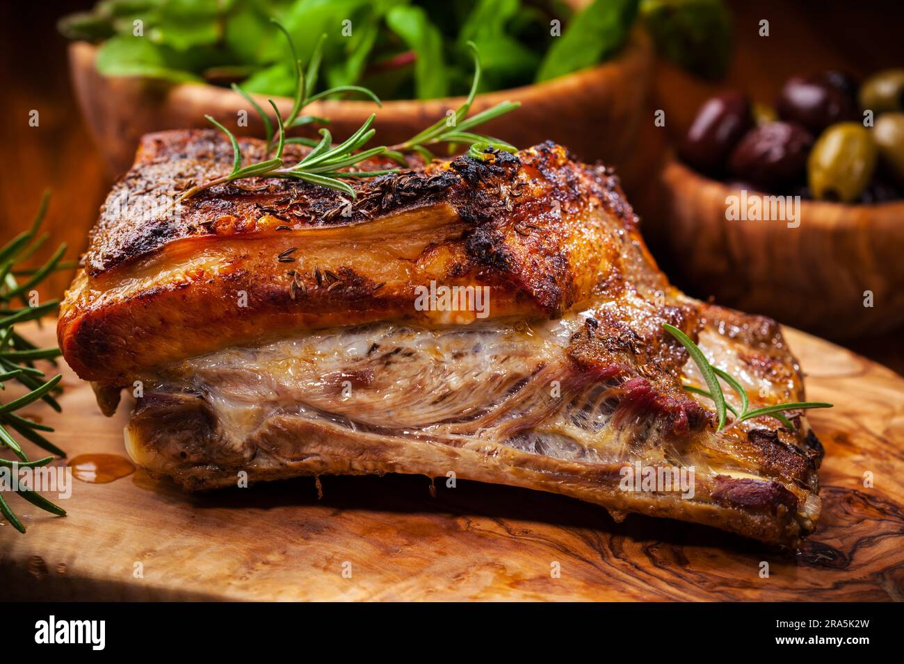Roasted pork with salad and olives Stock Photo