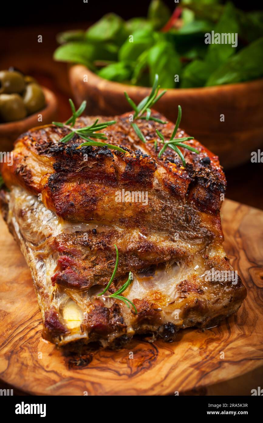 Roasted pork with salad and olives Stock Photo