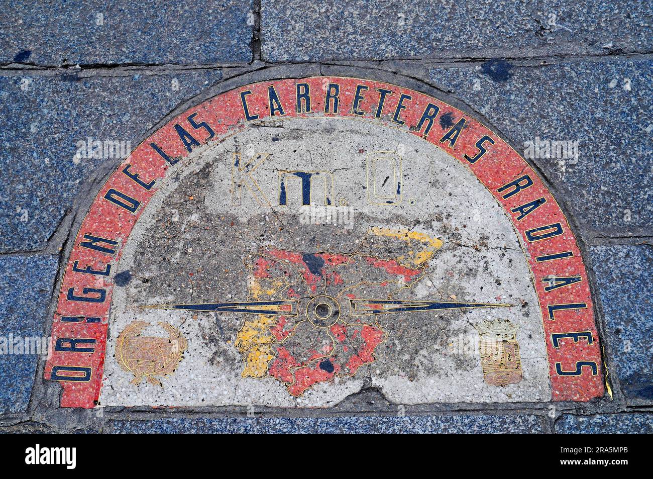 Zero kilometre stone, origen carreteras radiales, kilometro cero, pavement in front of post office building, Puerta del Sol, Madrid, Spain Stock Photo