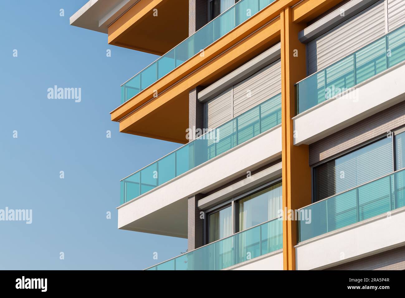 Image showcasing New apartment building with large balconies with glass railings. Modern ...
