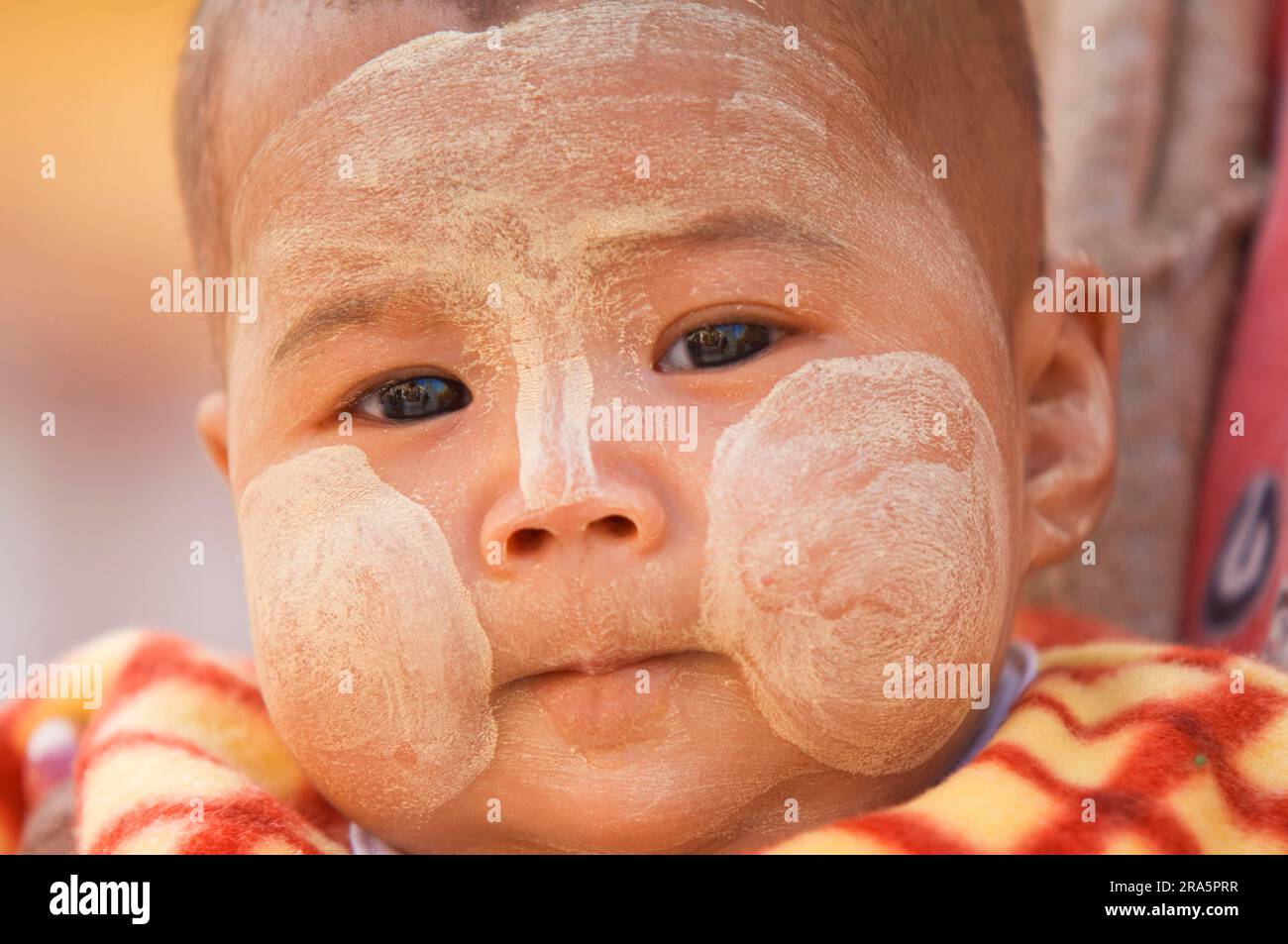 Burmese baby with thanaka paste on face, Bagan, Burma, Pagan, Myanmar