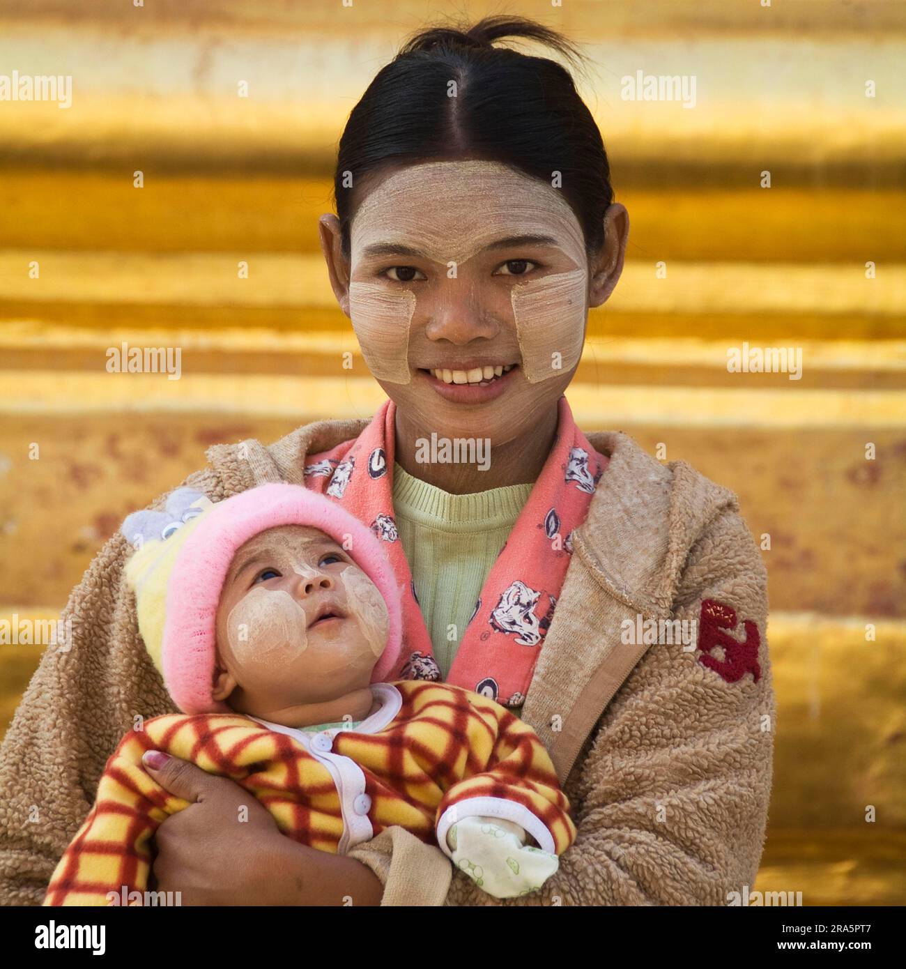 Young Burmese woman with baby, thanaka paste on face, Bagan, Burma