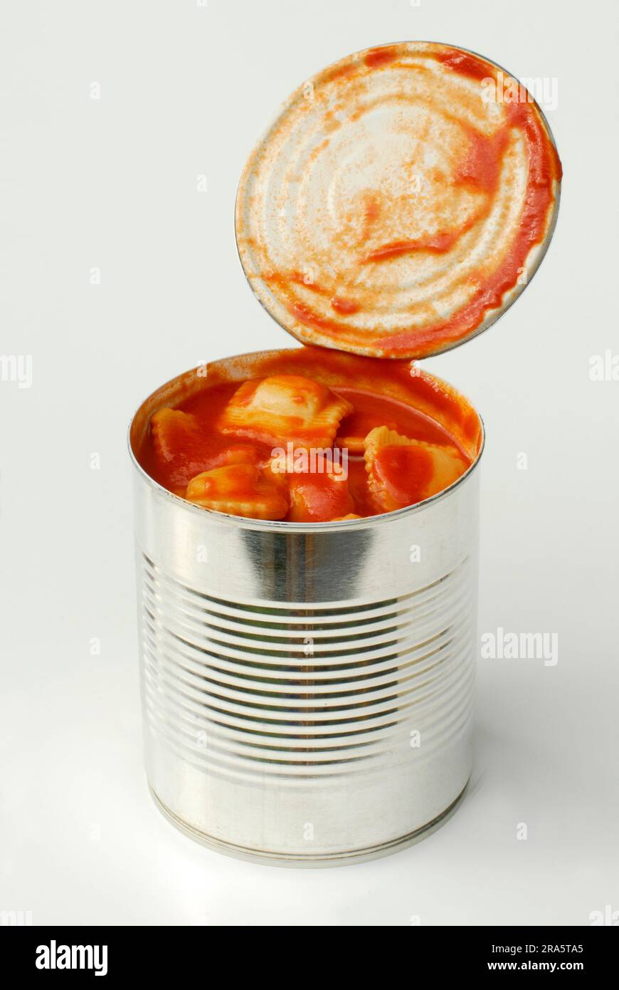 Opened tin of canned food with ravioli in tomato sauce, tin, noodles