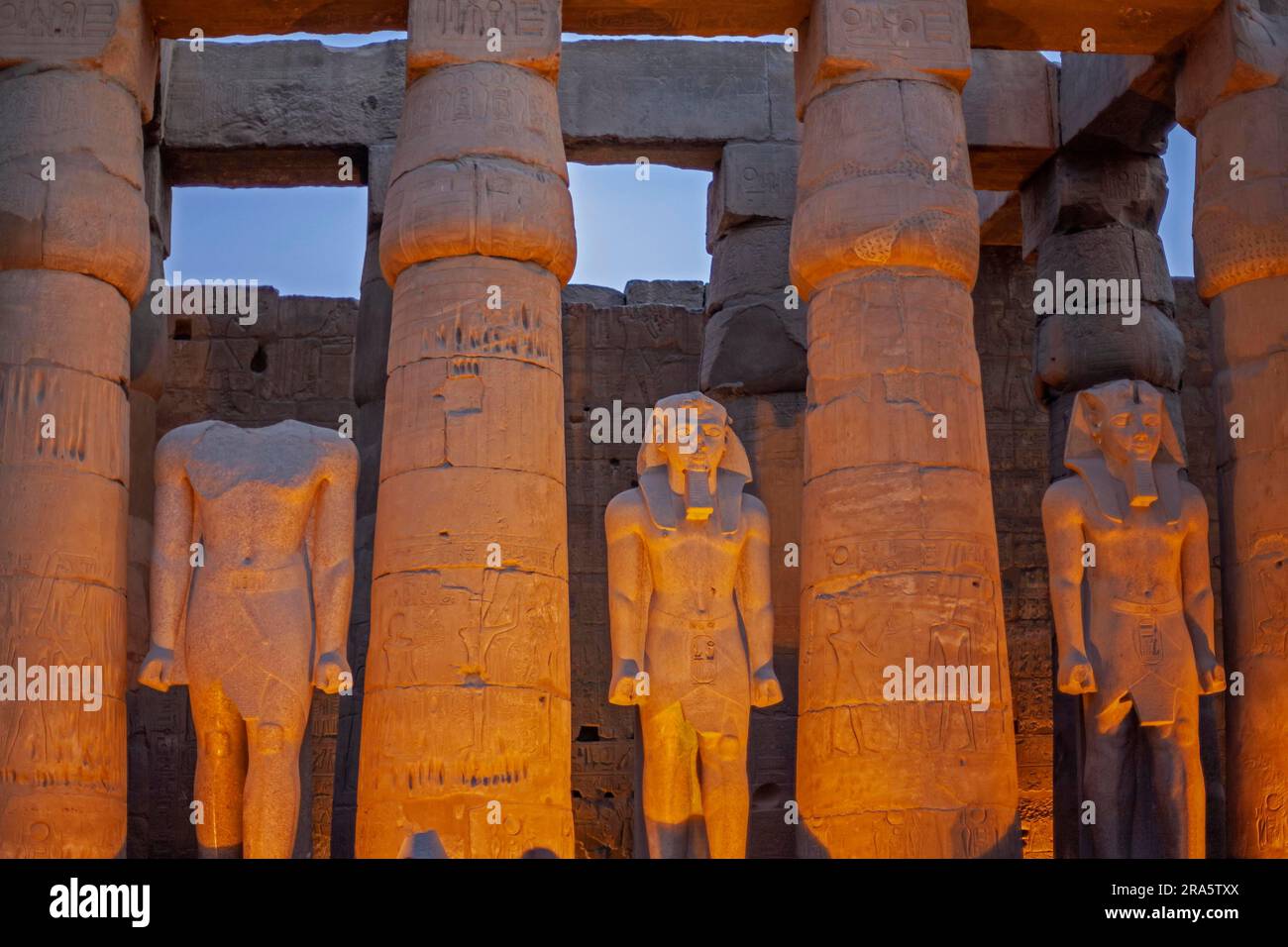 Statues in the Luxor temple in the evening Stock Photo - Alamy