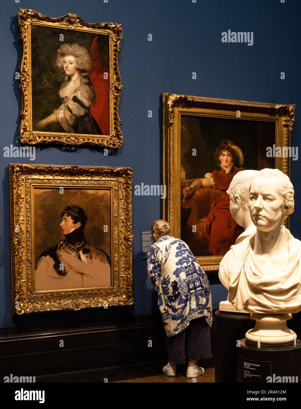 Woman looking closely at a painting in The National Portrait Gallery ...