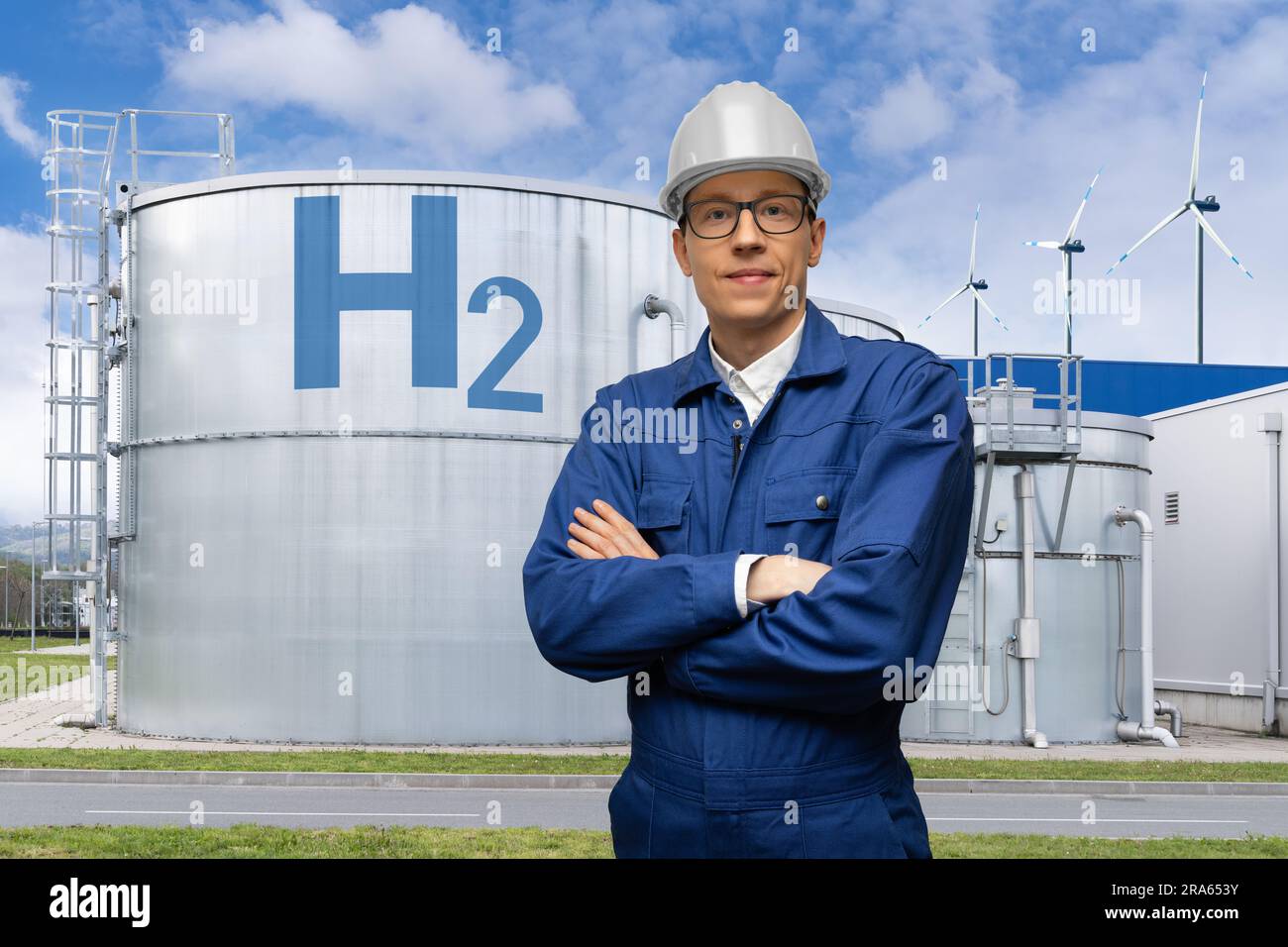 Engineer in helmet on a background of Hydrogen factory. Stock Photo