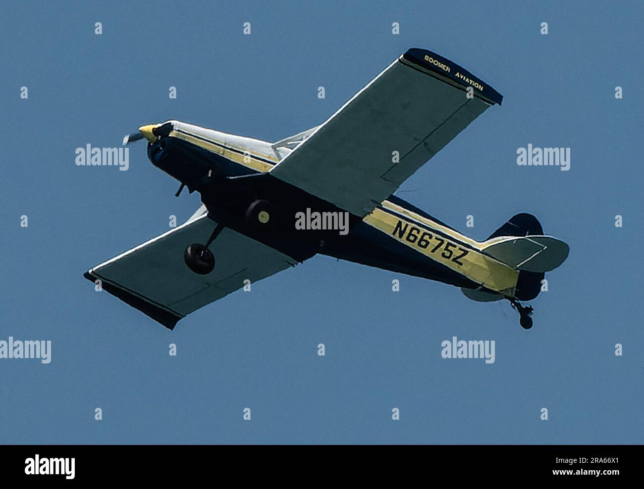 Old propeller driven plane flying off the beach in Florida Stock Photo