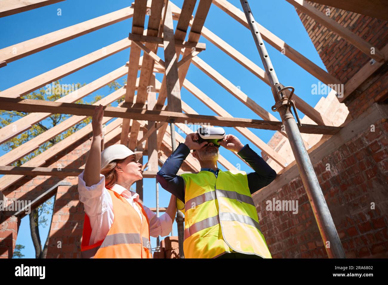 Main construction worker wearing vr-glasses to see 3d model of house Stock Photo