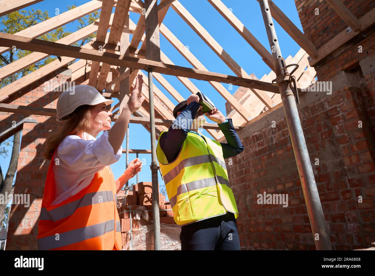Foreman using virtual reality headset for vision of constructed building result Stock Photo