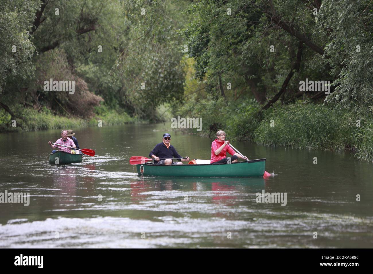 Ditfurt, Germany. 01st July, 2023. Water sports enthusiasts ride canoes on the Bode River. A boat rental offers water recreation on the Bode. Visitors can experience the Bode and the Bode floodplain on a long section from the waterway and make acquaintance with the diverse flora and fauna along this river. The tours can last from three to six hours. Credit: Matthias Bein/dpa/ZB/dpa/Alamy Live News Stock Photo