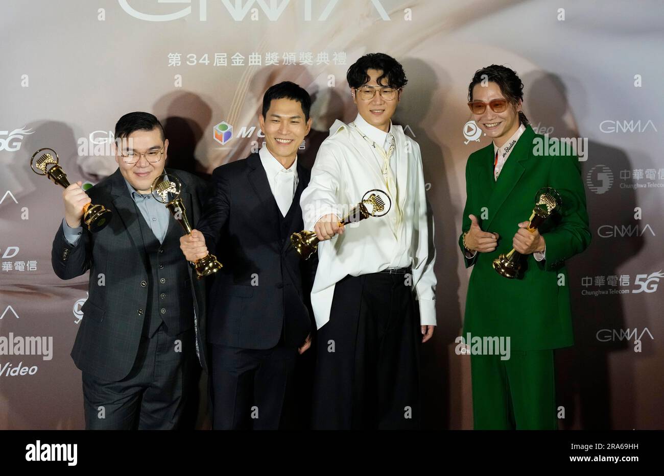 Taiwanese pop group Cosmos People hold their awards as Best